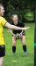 Young girl in black athletic clothing holding a ball