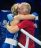 A female boxer and trainer hugging